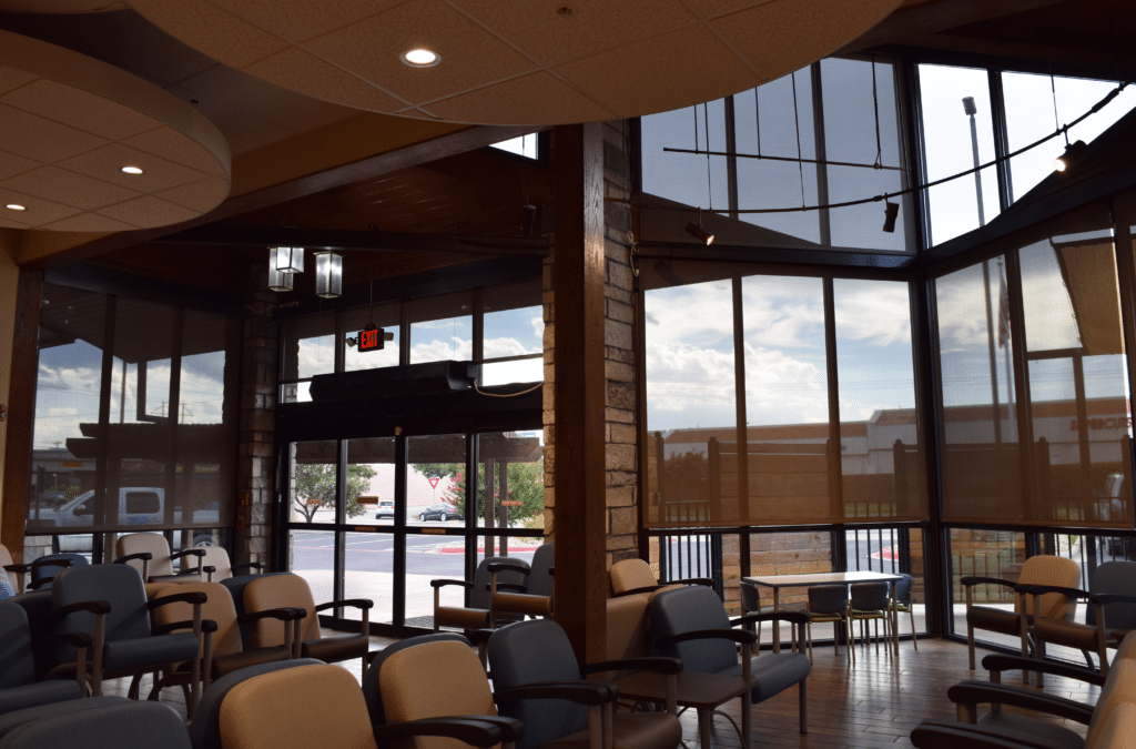Waiting area with chairs, windows, and an exit sign. Portfolio.