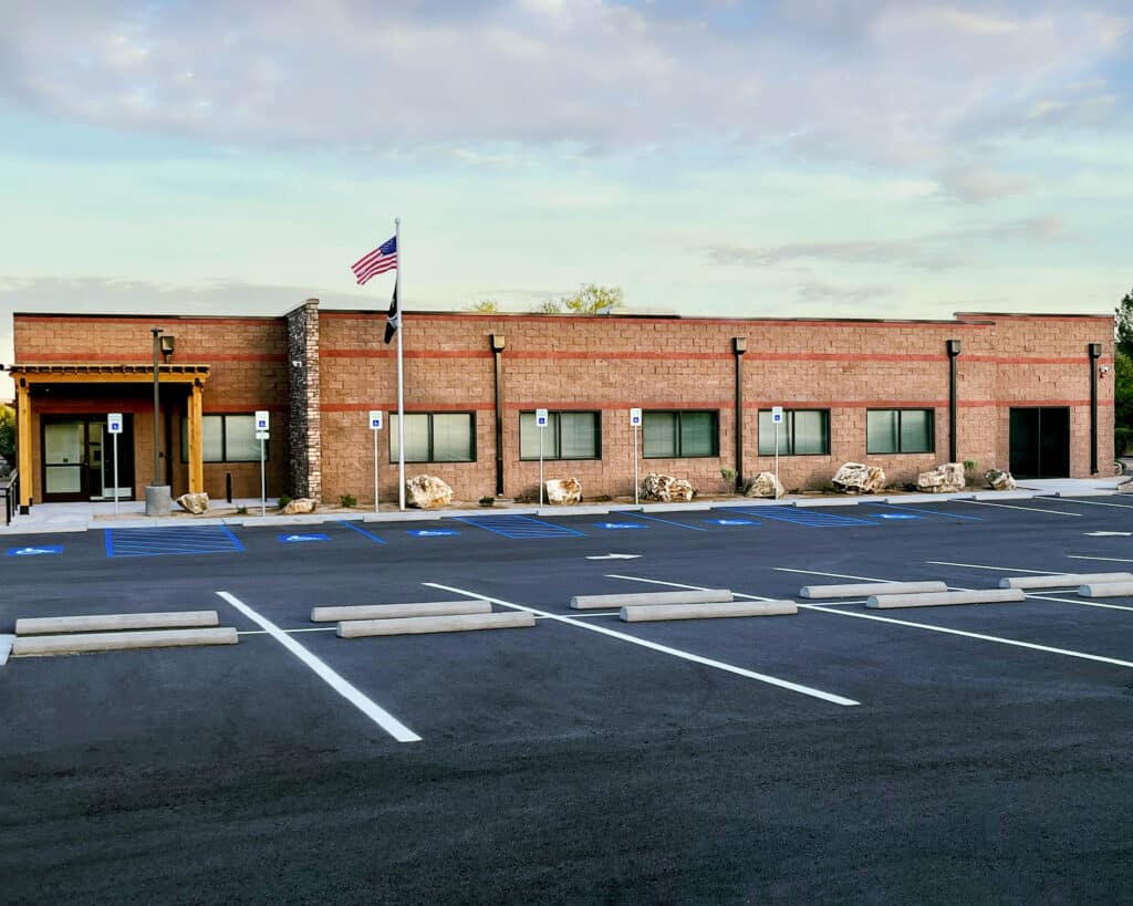 Brick building with accessible parking, American flag. Portfolio.
