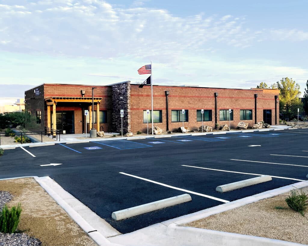 Modern brick building with accessible parking and US flag. Portfolio showcase.
